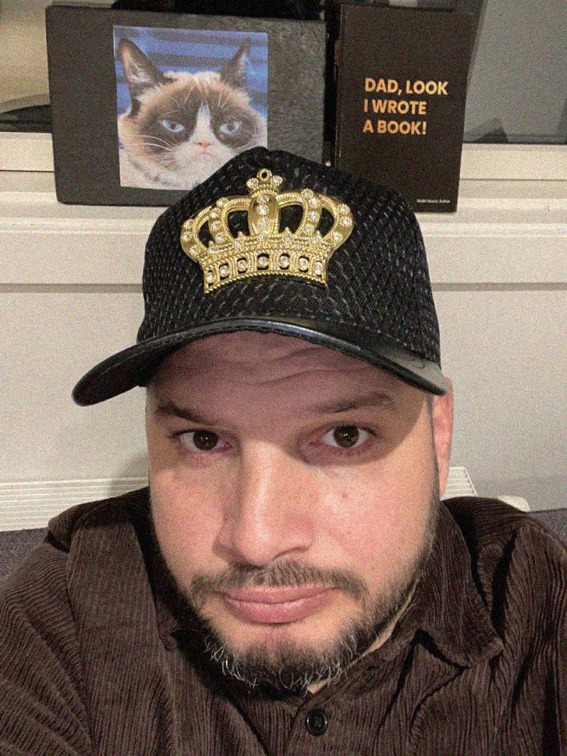 Abdel Seoud in a cap with a gold crown